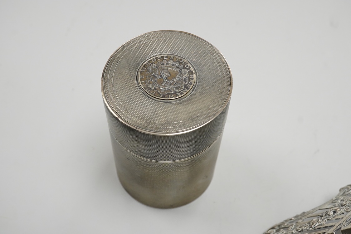 A German pierced 800 standard white metal bowl, 21.2cm, an engine turned white metal cigarette canister and a silver mounted glass dressing table pot.